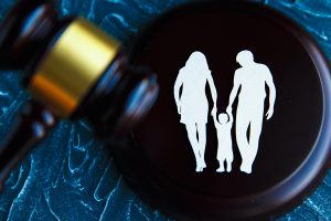Gavel and a picture of a family. Family law concept